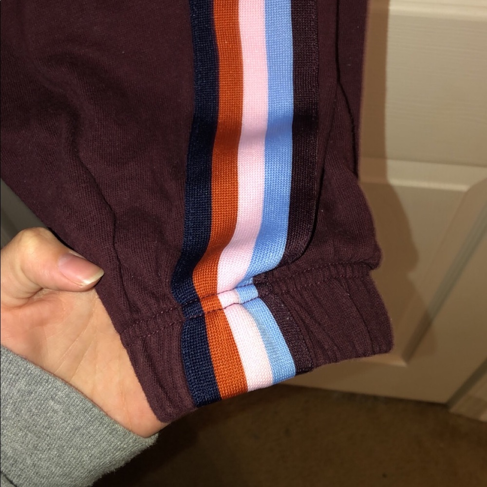 Maroon sweatpants with color stripes